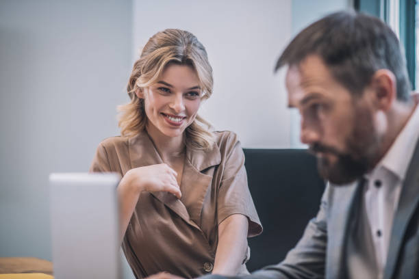 istock Concerned smiling woman and serious business man 1319259713
