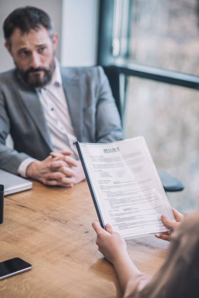 istock Frustrated adult boss and female hands with document 1319259786