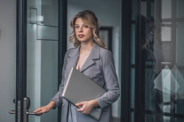 jovem elegante com porta de abertura de laptop - door office business women - fotografias e filmes do acervo