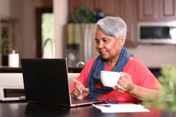istock Senior adult woman using laptop computer at home. 1319261184