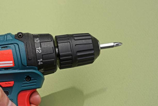 istock hand holds an electric black screwdriver 1319263292