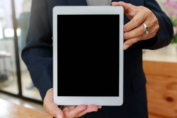 istock Man holding digital tablet in hand. Business man showing digital tablet with blank screen. 1319265431