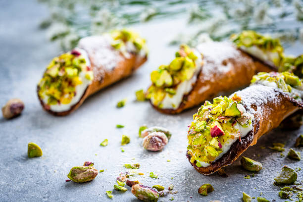 Typical Italian dessert Cannoli from Sicily Typical homemade Cannoli from Sicily shot on gray background. sicily stock pictures, royalty-free photos & images