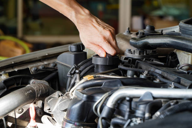 istock Asian mechanic is opening the oil cap from the engine. 1319267124