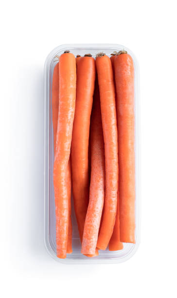 istock Sweet and crunchy imperator carrots in plastic container isolated on white 1319269078