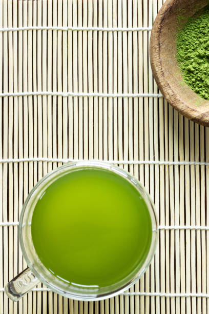 istock Matcha green tea and powder on bamboo mat 1319270998