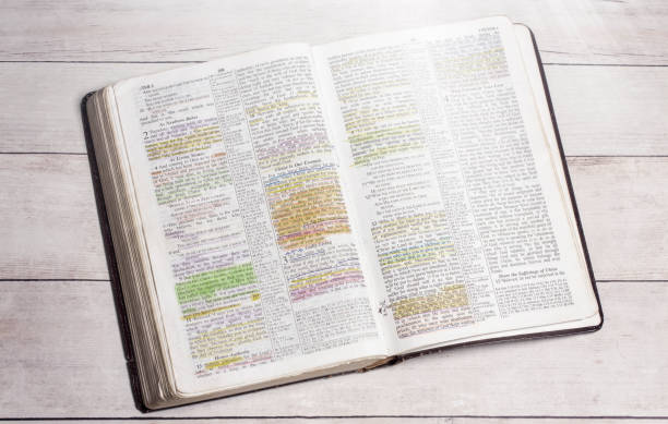 istock A Used and Highlighted Bible Open on a White Wood Table 1319273558