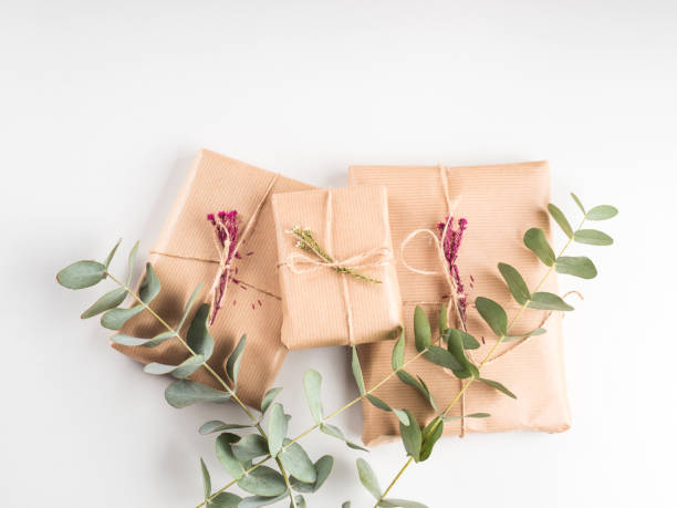 istock Wrapped gift boxes in craft paper with dried flowers decor 1319276256