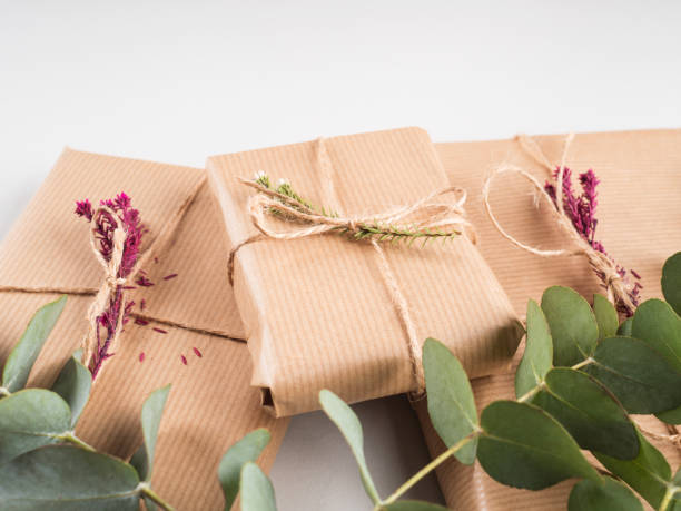 istock Wrapped gift boxes in craft paper with dried flowers decor 1319276262