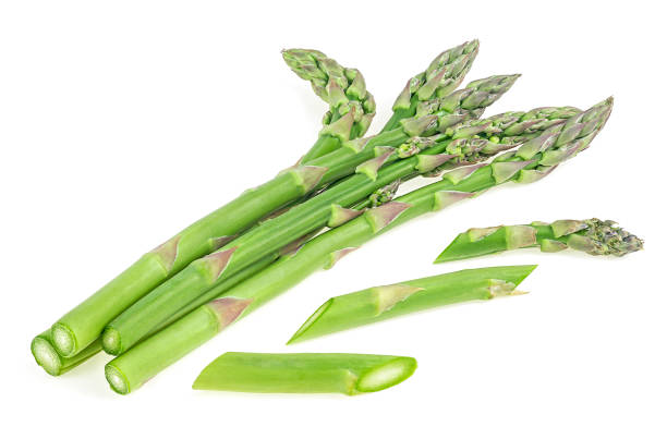 istock Asparagus sprouts and slices isolated on a white background. Raw asparagus shoots. 1319276783