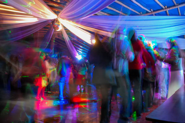 istock Crowd dancing under a disco ball and celebrating new's year on the dance floor. 1319281502