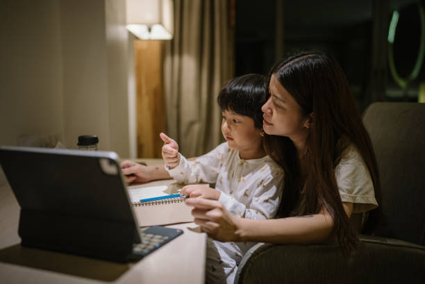 istock Mother helping son with homeschooling. 1319282708