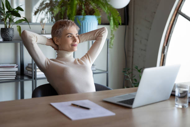 Happy businesswoman relax at workplace making plans