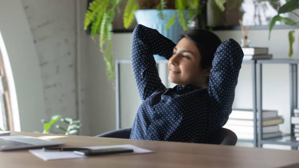 istock Indian female employee relax at workplace dreaming 1319284394