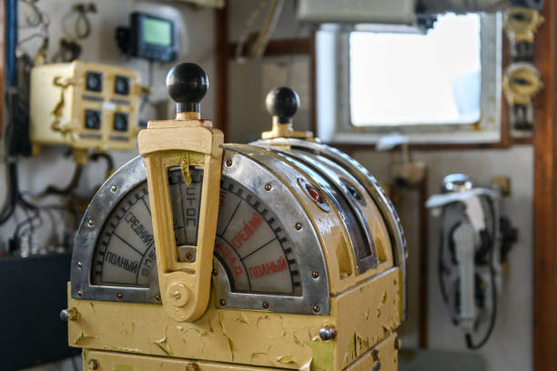 istock Navigational bridge on abandoned vessel. Old derelict ship wheelhouse. Ship's control device. Russian words: Ahead/Astern, full, half, slow, dead slow, stop, stand by. 1319284397