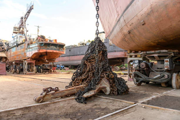 istock Anchor with chain ashore on ship repairing yard. 1319284440