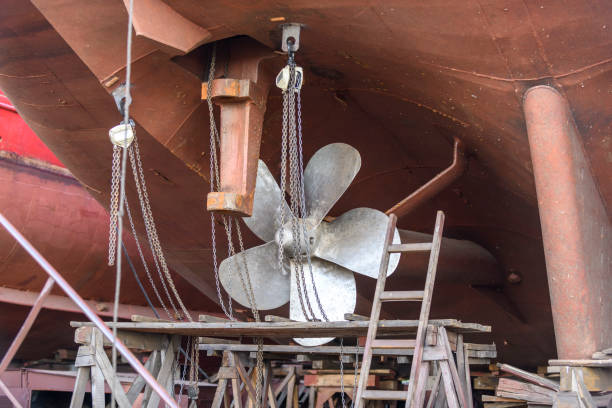 istock Fixed blade propeller and rudder. Cargo vessel ashore on ship repairing yard. 1319284587