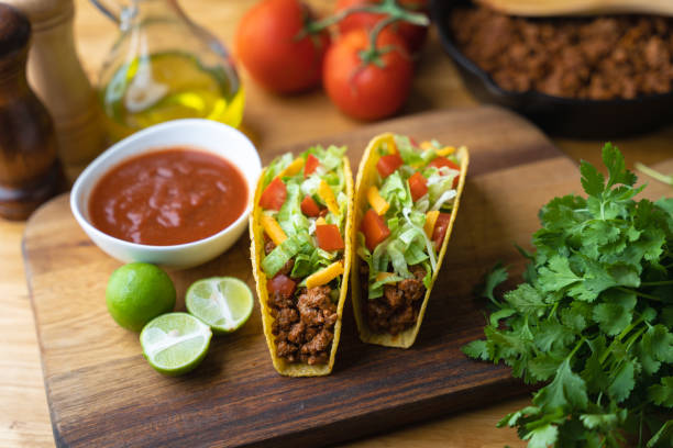 hard shell taco on wooden board with lime hard shell taco on wooden board with lime toughness photos stock pictures, royalty-free photos & images