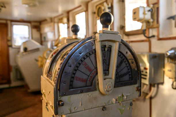 istock Navigational bridge on abandoned vessel. Old derelict ship wheelhouse. Ship's control device. Russian words: Ahead/Astern, full, half, slow, dead slow, stop, stand by. 1319285391