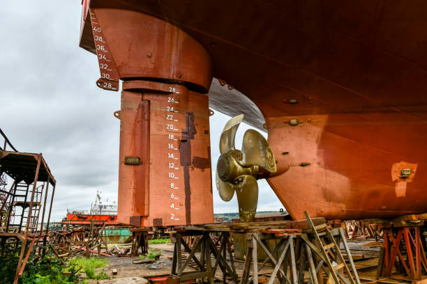 istock Variable pitch propeller and rudder. Cargo vessel ashore on ship repairing yard. 1319285500