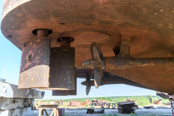 istock Fixed blade propeller and rudder with shells. Cargo vessel ashore on ship repairing yard. 1319285657