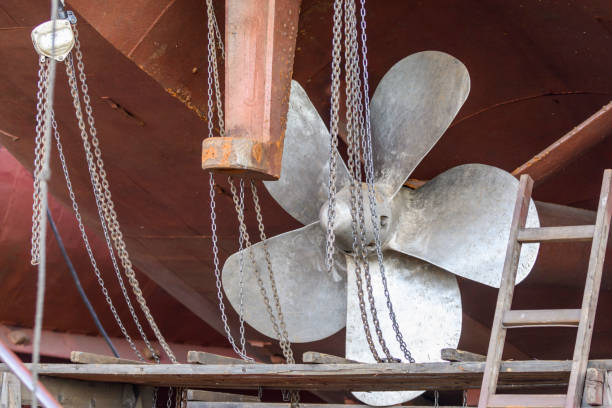Fixed blade propeller and rudder. Cargo vessel ashore on ship repairing yard.