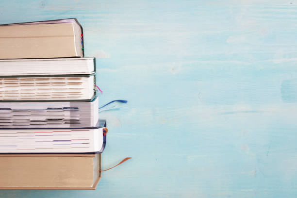 istock book border on blue wood background 1319285780
