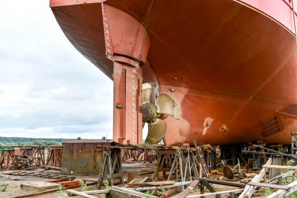 istock Variable pitch propeller and rudder. Cargo vessel ashore on ship repairing yard. 1319285815