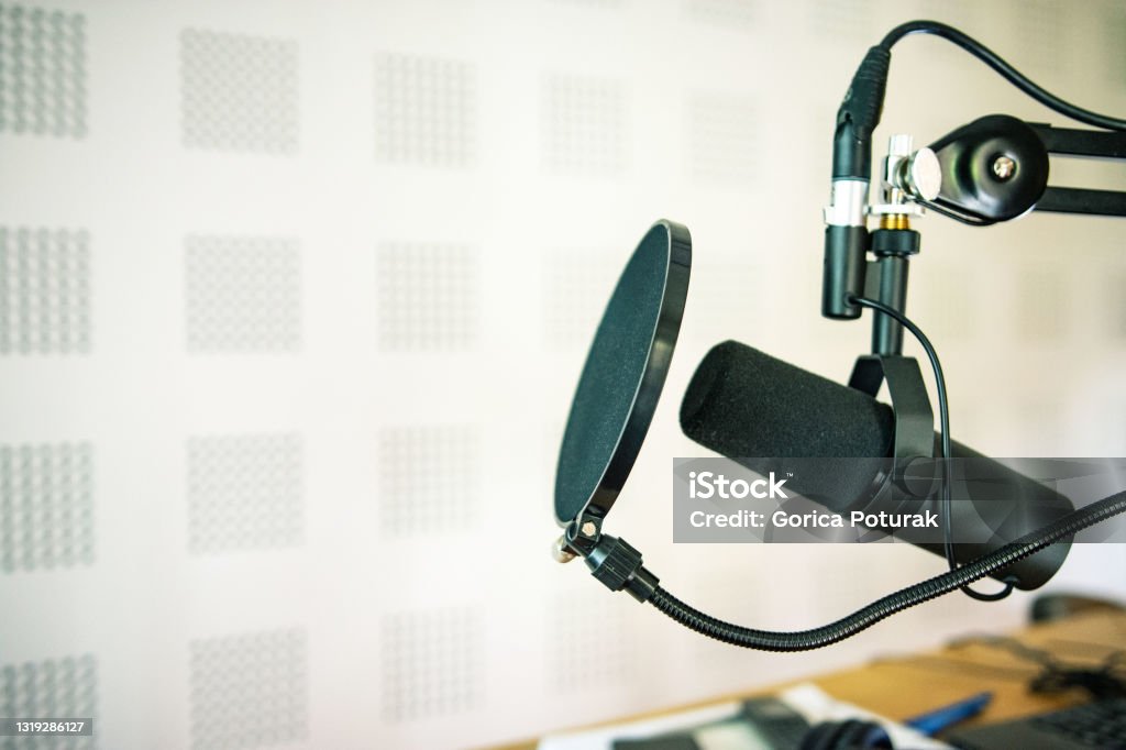 Radio station microphone in recording studio or broadcast room, working place of radio host, close up Podcasting Stock Photo