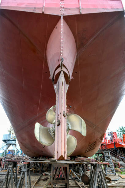 istock Variable pitch propeller and rudder. Cargo vessel ashore on ship repairing yard. 1319286160