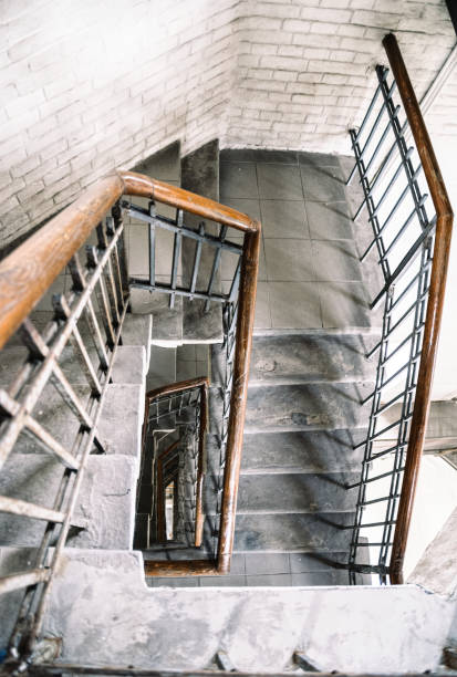 istock Old spiral staircase with wooden railing 1319287310