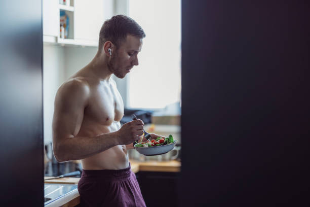 istock Handsome Sporty Man Holding Fresh Salad 1319287416