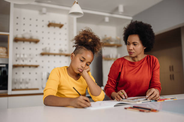 istock Mom is helping her daughter about something for school. 1319288980