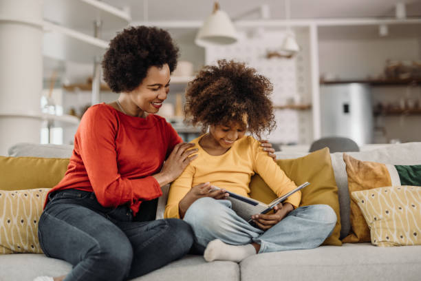 istock Daughter and mother, sitting on the couch. 1319288986