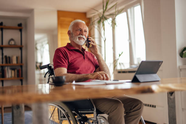 istock Disabled old man, making a business deal, at home office. 1319288988
