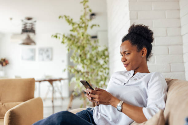 istock African woman using mobile phone, sending messages to someone. 1319289066