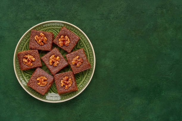 Middle eastern walnut semolina cake basbousa , namoora, hareesa . Traditional sweets celebration Eid , Ramadan . Top view with copy space