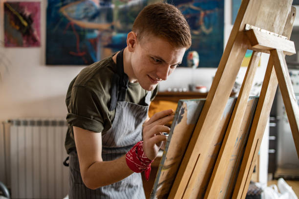 istock Young artist painting in his studio 1319289808