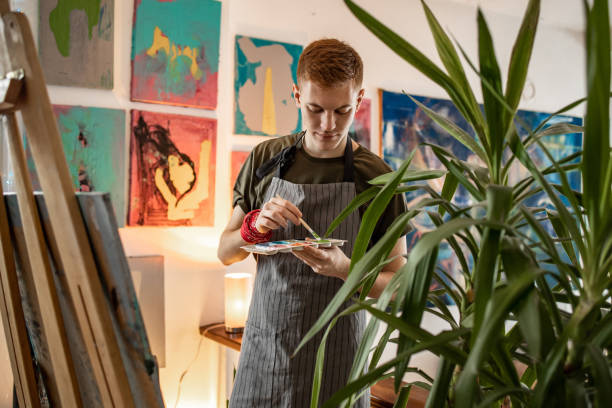istock Young artist painting in his studio 1319289810