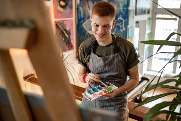 istock Young artist painting in his studio 1319290264