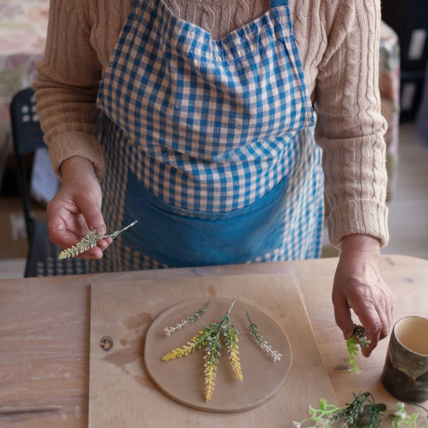 istock Senior female artisan creating handmade ceramics in pottery studio 1319290886