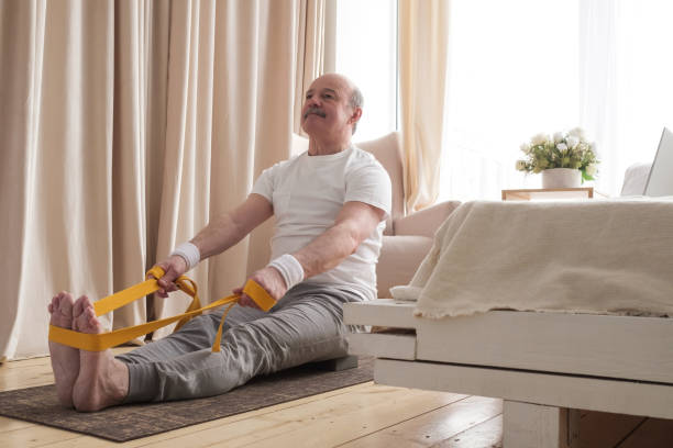 istock Senior man sitting in paschimottanasana or Intense Dorsal Stretch pose 1319291987