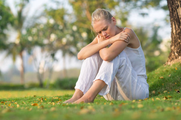 istock Sad depressed young woman sitting alone at the park. 1319294596