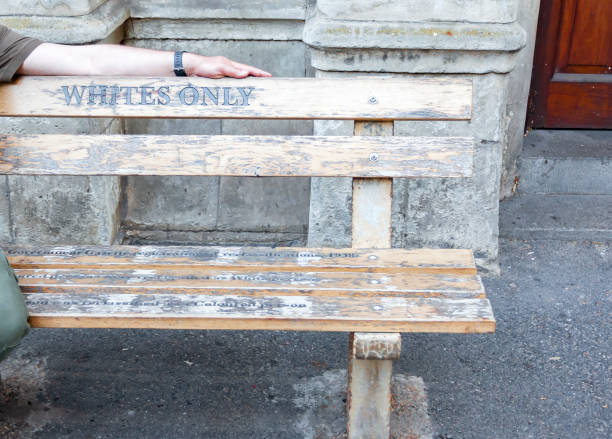 Only white - the inscription on the bench with the hand of  white man. Only white - the inscription on the bench with the hand of  white man. Part of   bench with an inscription commemorating apartheid and segregation in South Africa. segregation stock pictures, royalty-free photos & images