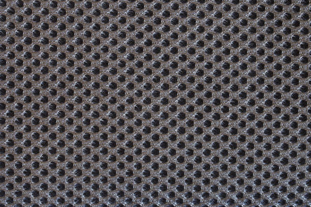 istock Dark gray textile surface with many small meshes. Orthopedic insert in the back of a modern backpack. Backdrop or background 1319300376