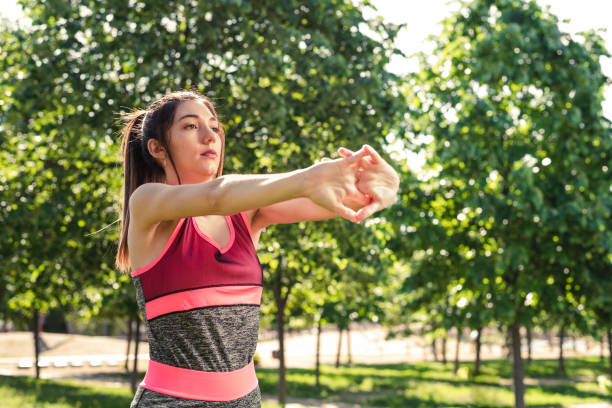 istock caucasian young athlete stretching her forearms at the park 1319301015