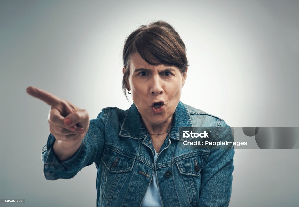 Studio portrait of a senior woman yelling against a grey background Obey as I say! Shouting Stock Photo