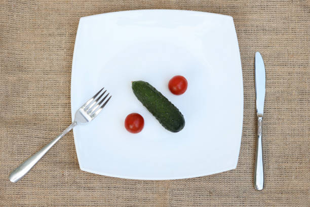 istock Fresh tomatoes in a plate. Collecting tomatoes. View from above 1319302839