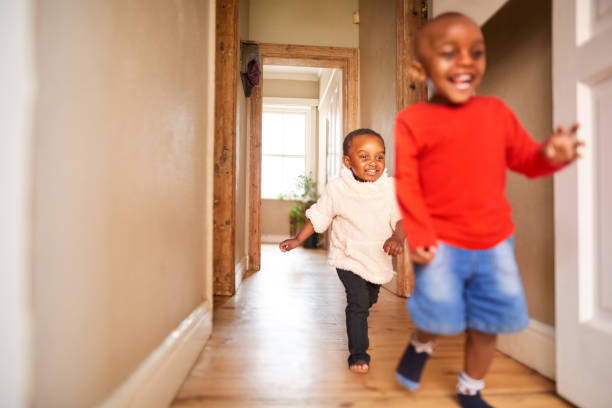 istock Boy playing with sister at home 1319310090