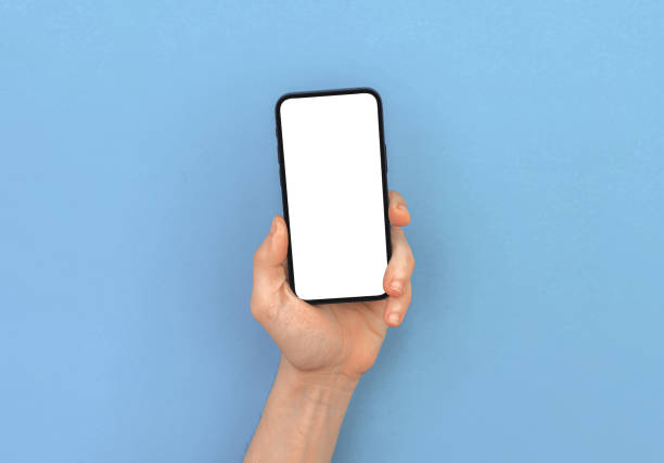 istock Man hand holds modern mobile phone mockup on bright pastel and colorful background, copy space 1319311296